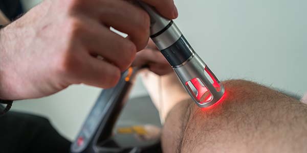 Laser Therapy On A Knee Used To Treat Pain with Regenerative Medicines